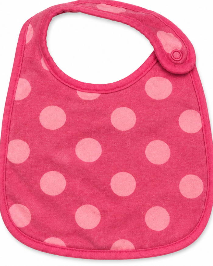 Pink bib with white polka dots on a white background