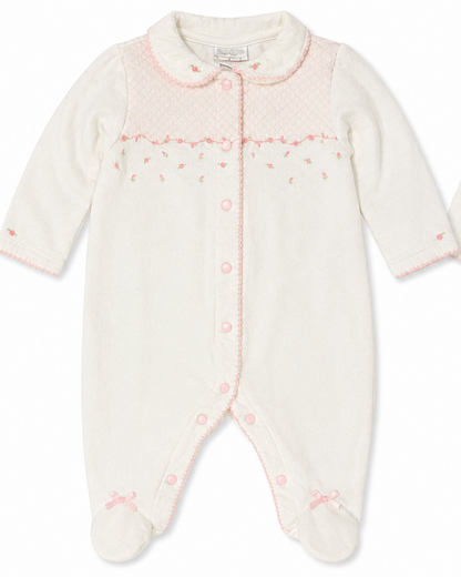 Baby onesie with pink floral pattern on a white background