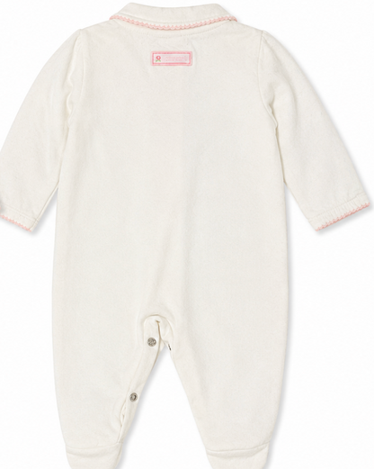 White baby onesie with pink trim on a white background