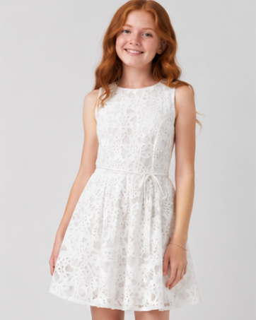 Young girl wearing a white lace dress on a plain background