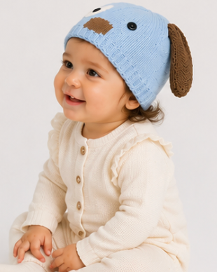 Baby wearing a blue knitted hat with dog ears and a brown nose on a white background
