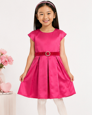 Young girl wearing a pink dress with a red belt on a white background