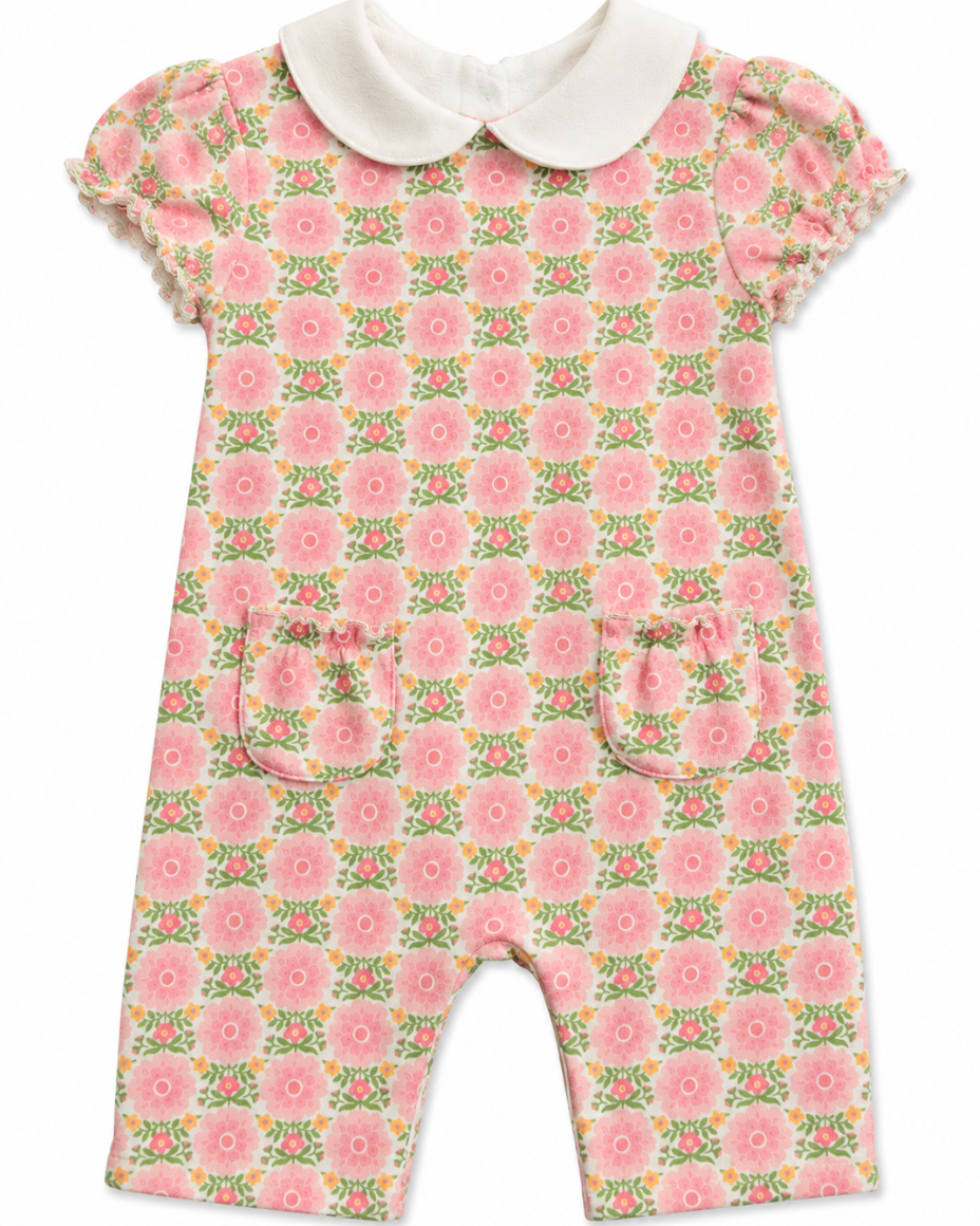 Floral baby romper with a white collar on a white background