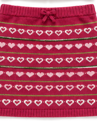 Red knitted skirt with heart pattern on a white background