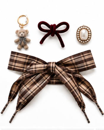 A flat-lay of three autumn-themed hair accessories on a white background: a large brown and beige plaid ribbon headband, a dark red velvet bow hair clip, and a small teddy bear keychain.