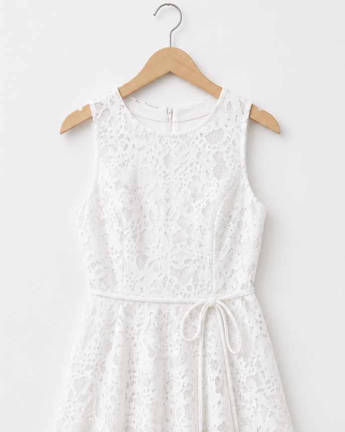 White lace dress on a wooden hanger against a white background