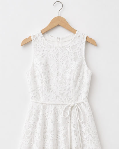 White lace dress on a wooden hanger against a white background