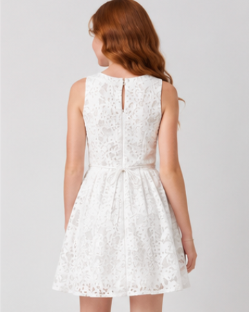 White lace dress on a model against a plain background