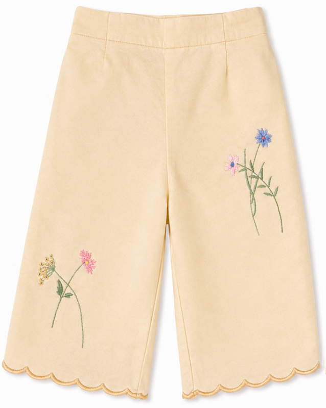 Yellow pants with floral embroidery on a white background
